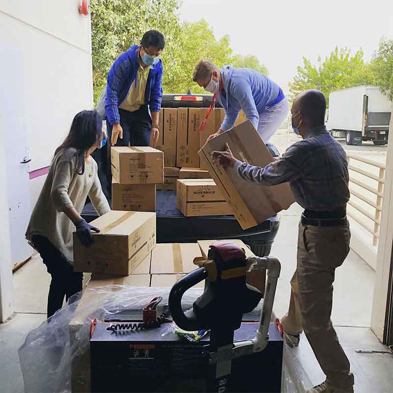 People carefully handling and coordinating a shipment